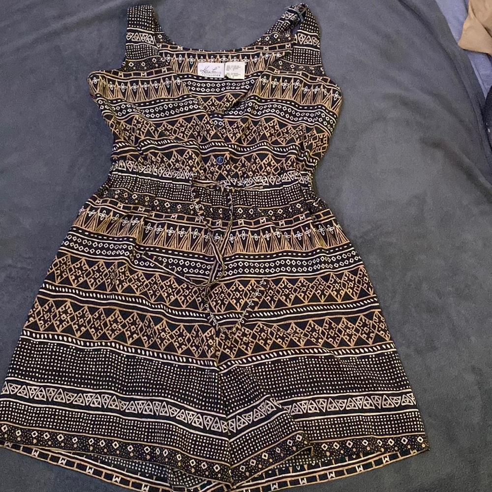 Small black, cream, and white romper